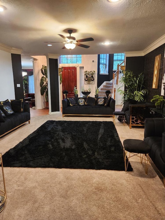 3226 Blackcastle Dr, Houston, TX 77068 - carpeted living room with ceiling fan, ornamental molding, and stairs