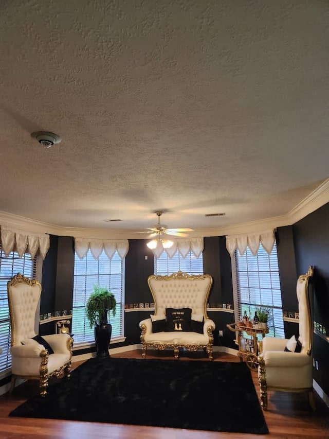 3226 Blackcastle Dr, Houston, TX 77068 - sitting room featuring crown molding, a textured ceiling, wood finished floors, and a healthy amount of sunlight