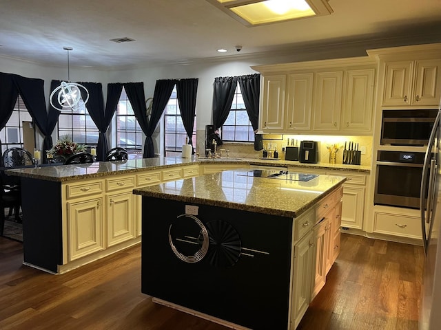 3226 Blackcastle Dr, Houston, TX 77068 - kitchen with visible vents, a sink, cream cabinetry, a peninsula, and stainless steel appliances