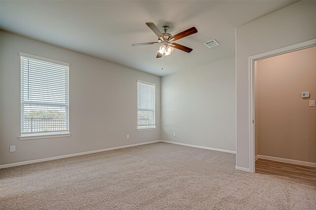 2203 Manila, Texas City, TX 77568 - carpeted empty room with visible vents, ceiling fan, and baseboards
