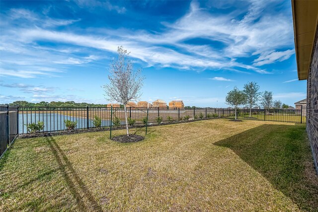 2203 Manila, Texas City, TX 77568 - view of yard featuring a water view and a fenced backyard