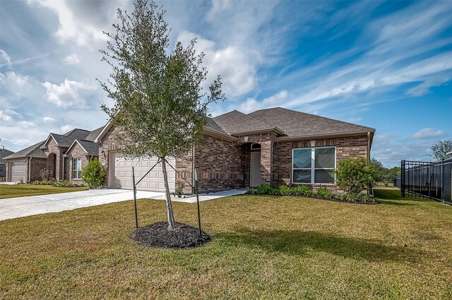 2203 Manila, Texas City, TX 77568 - ranch-style house featuring a front yard, brick siding, driveway, and an attached garage