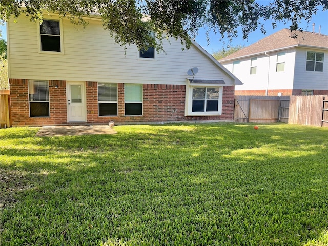 15318 Redbud Berry Way, Cypress, TX 77433 - back of property with brick siding, a fenced backyard, a lawn, and a patio area