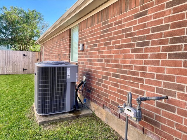 15318 Redbud Berry Way, Cypress, TX 77433 - details with brick siding, central AC, and fence