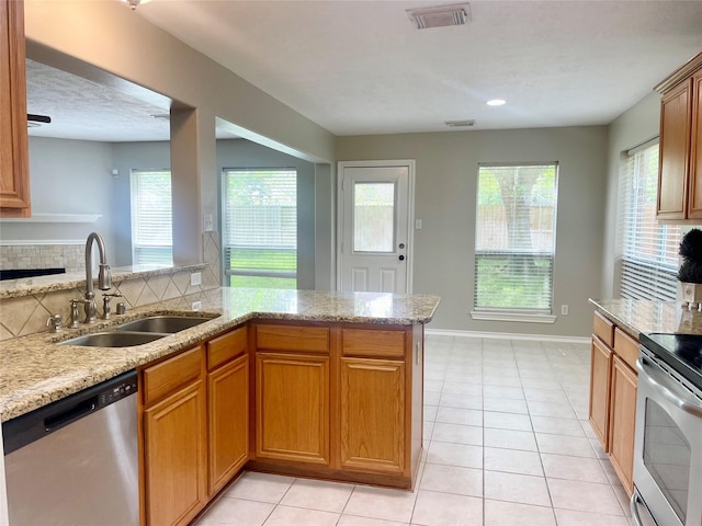 15318 Redbud Berry Way, Cypress, TX 77433 - kitchen featuring a sink, visible vents, light stone countertops, and stainless steel appliances