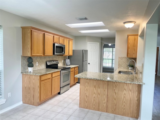 15318 Redbud Berry Way, Cypress, TX 77433 - kitchen with backsplash, visible vents, a skylight, stainless steel appliances, and a sink