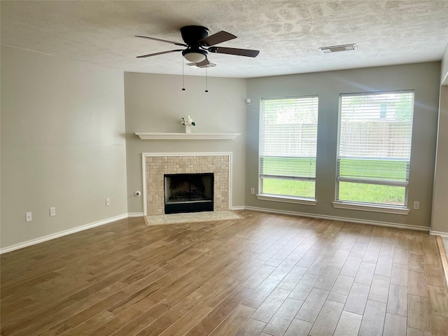 15318 Redbud Berry Way, Cypress, TX 77433 - unfurnished living room featuring visible vents, baseboards, ceiling fan, and wood finished floors