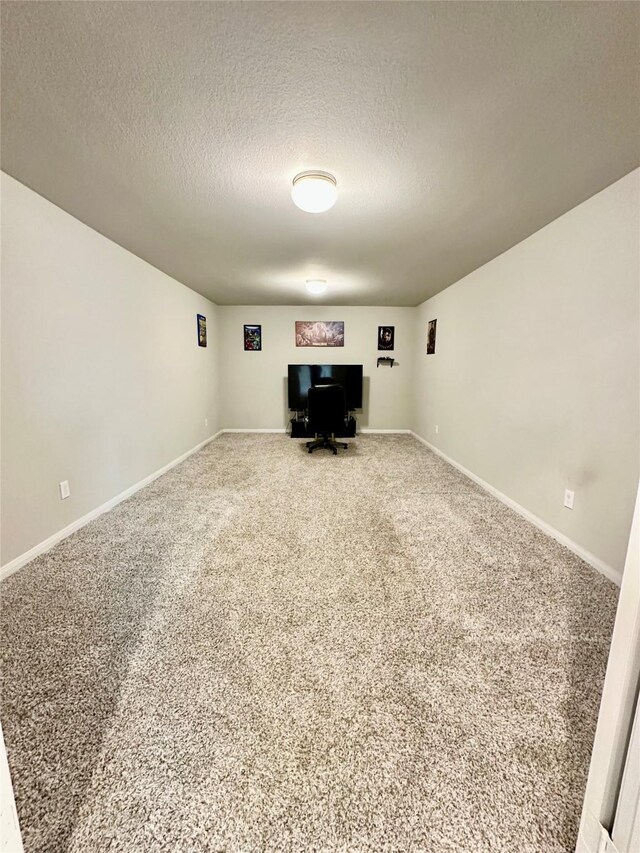 31503 Sandpiper Creek Dr, Hockley, TX 77447 - unfurnished living room with a textured ceiling, an office area, carpet floors, and baseboards
