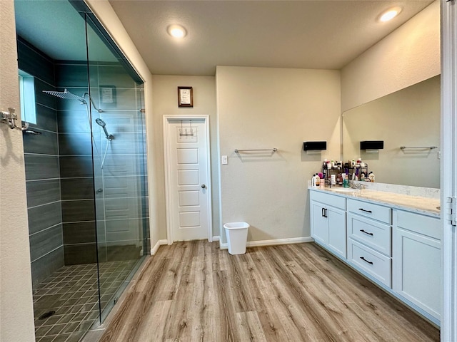 31503 Sandpiper Creek Dr, Hockley, TX 77447 - bathroom featuring wood finished floors, a shower stall, vanity, and baseboards