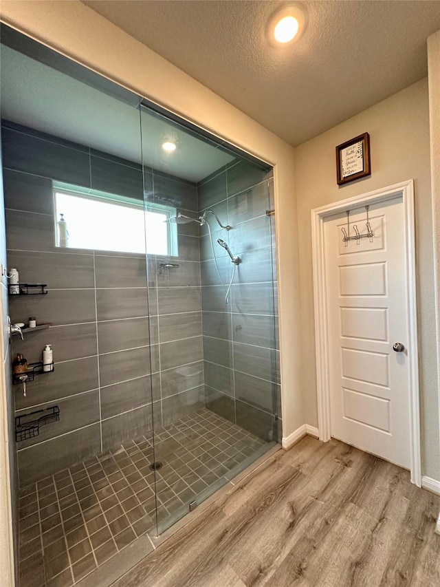 31503 Sandpiper Creek Dr, Hockley, TX 77447 - full bath featuring a shower stall, wood finished floors, a textured ceiling, and baseboards