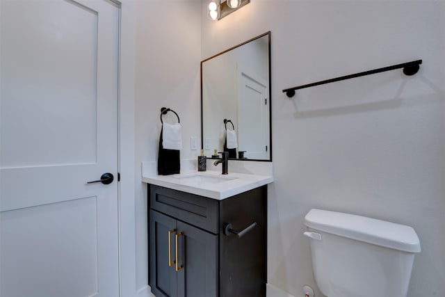 half bathroom with vanity and toilet