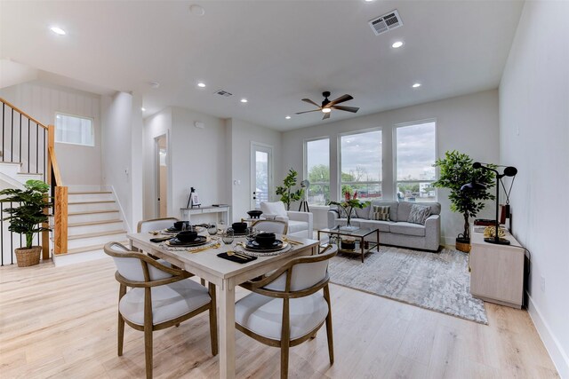 dining space featuring light wood-type flooring, recessed lighting, visible vents, and stairs