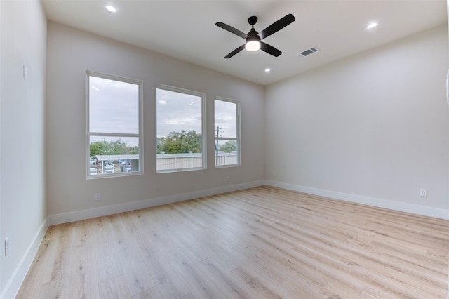 empty room with visible vents, baseboards, ceiling fan, light wood-type flooring, and recessed lighting