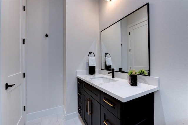 bathroom with baseboards and vanity