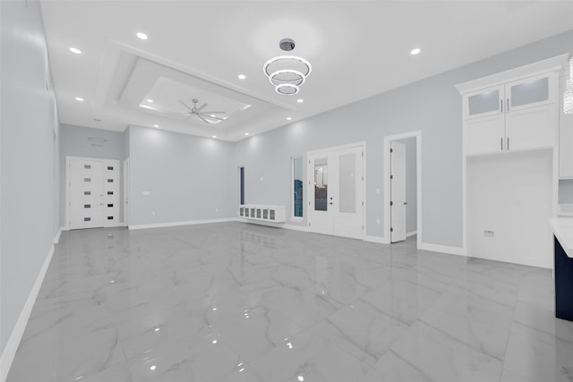 3007 E Ebano Ave, Hidalgo, TX 78557 - unfurnished living room featuring a ceiling fan, light marble finish floors, recessed lighting, and a tray ceiling