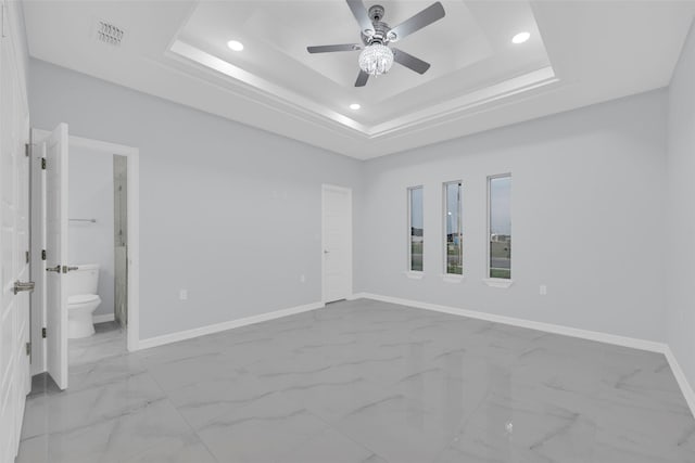 3007 E Ebano Ave, Hidalgo, TX 78557 - unfurnished bedroom with marble finish floors, recessed lighting, a tray ceiling, connected bathroom, and a ceiling fan