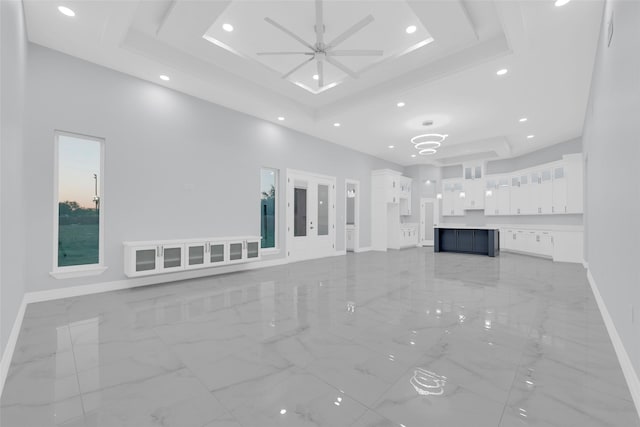 3007 E Ebano Ave, Hidalgo, TX 78557 - unfurnished living room featuring light marble finish floors, a tray ceiling, recessed lighting, and a ceiling fan