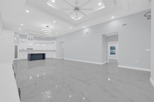 3007 E Ebano Ave, Hidalgo, TX 78557 - unfurnished living room featuring a ceiling fan, a raised ceiling, recessed lighting, and light marble finish floors