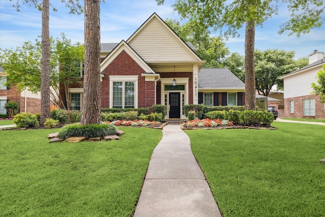 view of front of house featuring a front lawn and brick siding