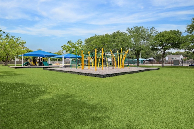 communal playground with a lawn and fence