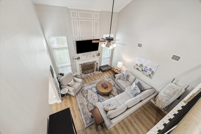 living room featuring visible vents, a ceiling fan, and high vaulted ceiling