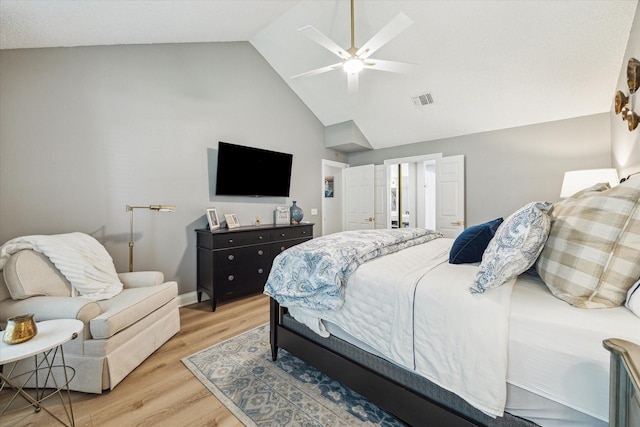 bedroom with high vaulted ceiling, ceiling fan, light wood-style flooring, baseboards, and visible vents