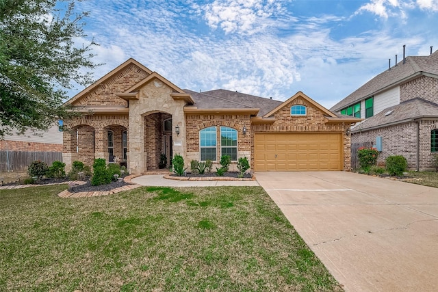 french country home with driveway, a front lawn, brick siding, a garage, and fence