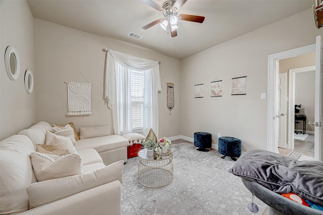 living room with visible vents, baseboards, and a ceiling fan