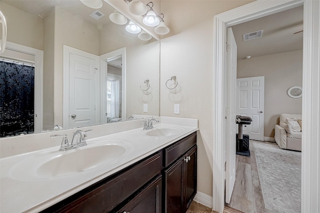 bathroom featuring double vanity, a sink, and visible vents