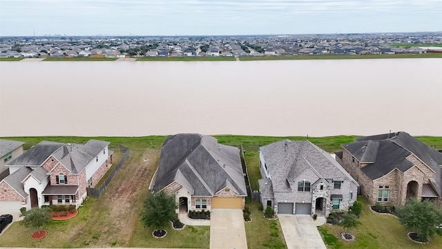 birds eye view of property with a residential view and a water view