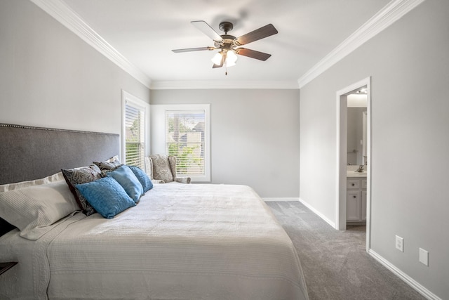 bedroom featuring carpet floors, crown molding, baseboards, and connected bathroom