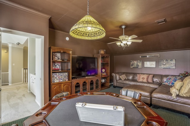carpeted living area with vaulted ceiling, a ceiling fan, crown molding, baseboards, and visible vents
