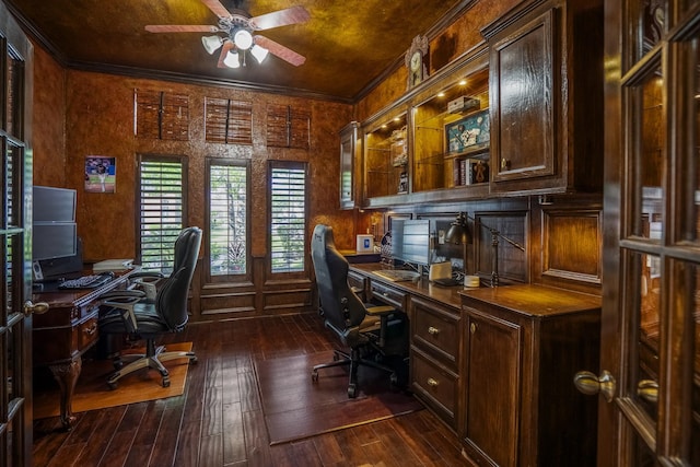office area with built in study area, a ceiling fan, dark wood-style floors, and ornamental molding