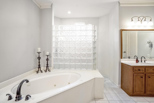 bathroom with a jetted tub, tile patterned flooring, and vanity