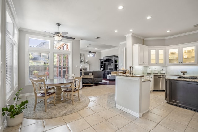 kitchen featuring white cabinets, light stone counters, dishwasher, crown molding, and ceiling fan