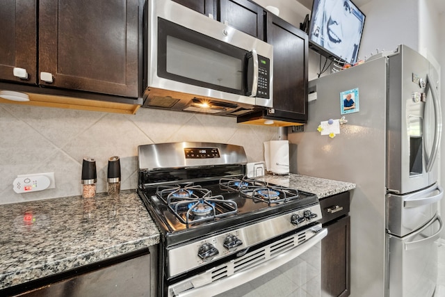 kitchen featuring dark brown cabinetry, tasteful backsplash, stainless steel appliances, and stone counters