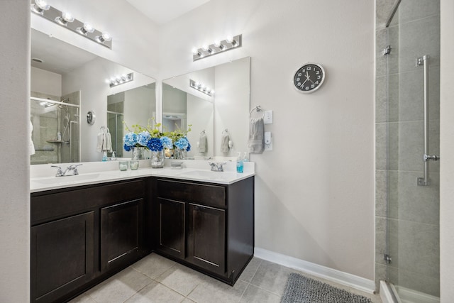 bathroom featuring tile patterned flooring, a sink, double vanity, and a stall shower