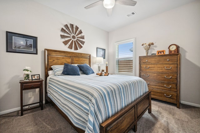 carpeted bedroom with baseboards, a ceiling fan, and visible vents