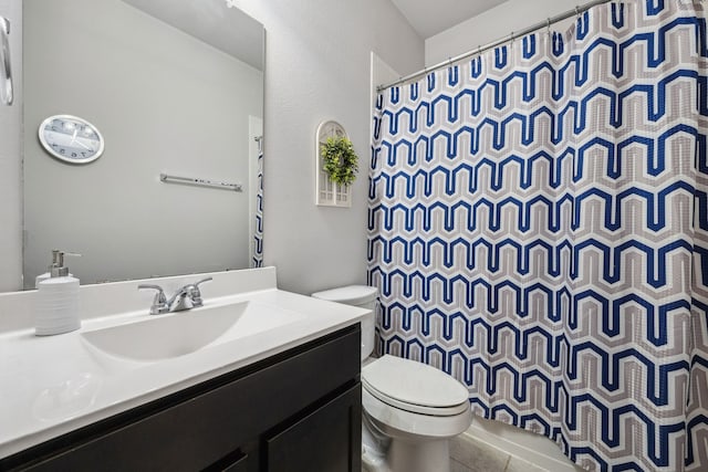 bathroom with tile patterned flooring, vanity, curtained shower, and toilet