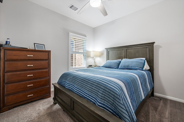carpeted bedroom with visible vents, baseboards, and ceiling fan