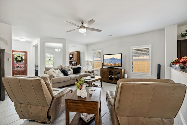 living area featuring a ceiling fan and visible vents