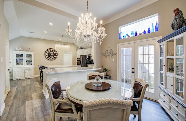 dining room featuring french doors, baseboards, an inviting chandelier, and wood finished floors