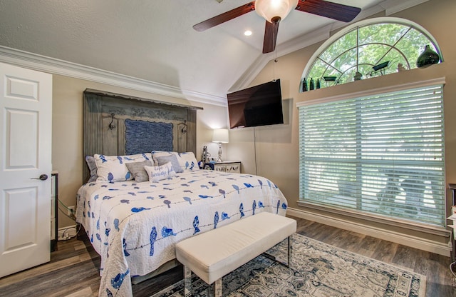 bedroom with vaulted ceiling, crown molding, a ceiling fan, and wood finished floors