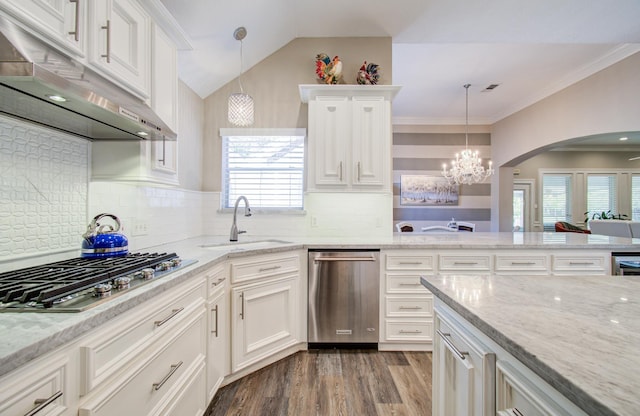 kitchen with a sink, a chandelier, under cabinet range hood, white cabinetry, and stainless steel appliances