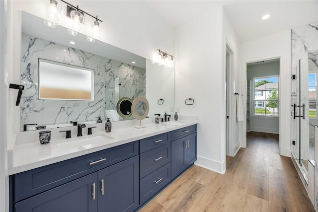 3314 Arbor, Houston, TX 77004 - full bathroom featuring a marble finish shower, wood finished floors, double vanity, and baseboards