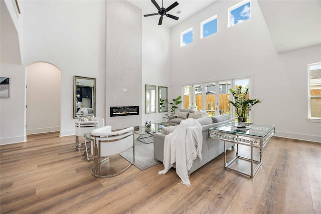 3314 Arbor, Houston, TX 77004 - living room with a high ceiling, wood finished floors, a ceiling fan, arched walkways, and baseboards