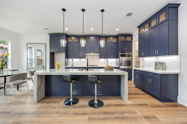 3314 Arbor, Houston, TX 77004 - kitchen with backsplash, light wood-style flooring, stainless steel double oven, blue cabinets, and recessed lighting