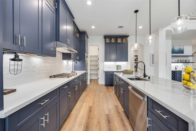 3314 Arbor, Houston, TX 77004 - kitchen with appliances with stainless steel finishes, a sink, under cabinet range hood, light wood-style floors, and backsplash