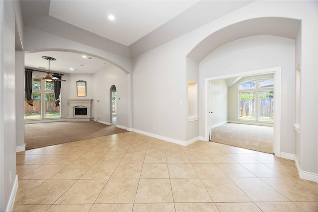 2423 Rosillos Peak Dr, Spring, TX 77386 - unfurnished living room with light colored carpet, a ceiling fan, light tile patterned flooring, and recessed lighting