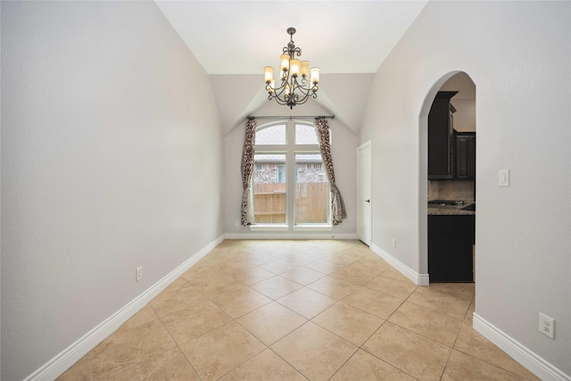 2423 Rosillos Peak Dr, Spring, TX 77386 - unfurnished dining area featuring a chandelier, light tile patterned floors, arched walkways, lofted ceiling, and baseboards